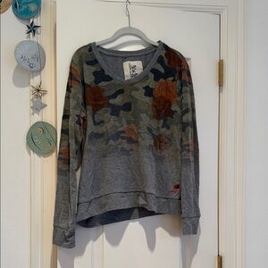 Camouflage Long Sleeve Top with Floral Accents and finger holes on the sleeves